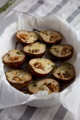 Homemade Blue Cheese Stuffed Pears with Honey, Thyme and Walnuts, side view.