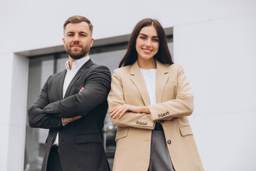Portrait of a team and partners of a young business man and woman standing outside the office...