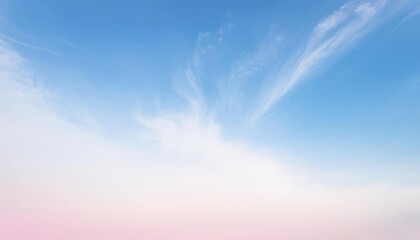A clear blue sky with delicate white clouds against a soft pink horizon.