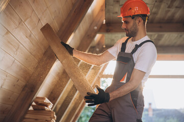 Process of construction new and modern modular house. Worker man in special protective uniform wear...
