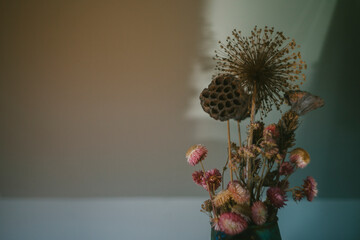 An arrangement of dried flowers with room for copy