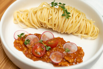 Close up health food's recipe Ingredients of special menu homemade cooking raw spaghetti with tomato sauce dice radish of macro photo focus shooting placing elements serving on white plate. Postulate.