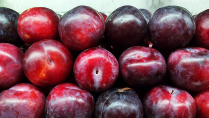 Fresh ripe plums as background
