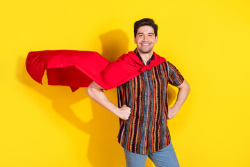 Photo of nice young man wear posing superhero costume isolated on yellow color background