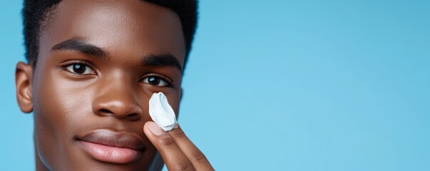 A man starting his day with a skincare routine, applying a hydrating cream to maintain a fresh look.