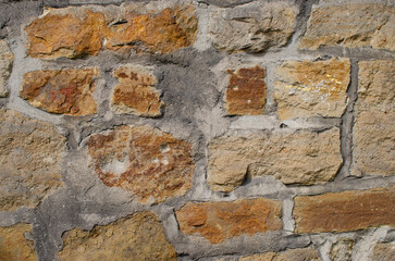 Old stone wall with weathered bricks