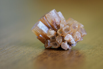 A small druse of aragonite lying on the table.
