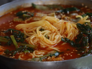 korean cold kimchi noodles noodles with green vegetables and red sauce
