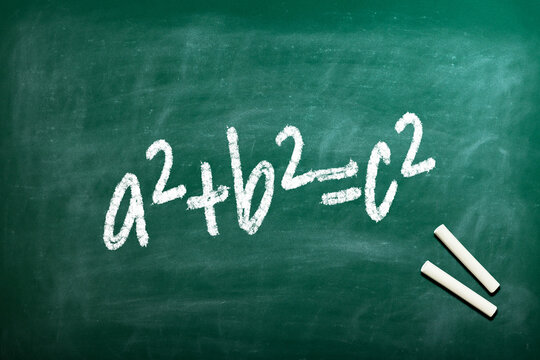 Pythagorean theorem a2+b2=c2 the famous formula to calculate the hypotenuse of a triangle written on an old fashioned blackboard 