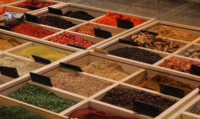 containers of colorful spices like pepper curry cardamom and others from all over the world for...