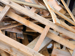 old broken pallets in the landfill container for recycling used wood