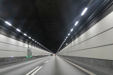 High-speed road tunnel view from a fast-moving car. Road and railway tunnel and blidge connecting Denmark and Sweden.