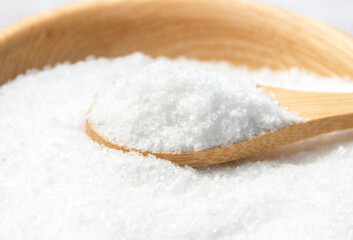 Salt in a wooden spoon close-up.