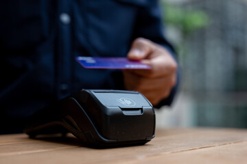 Customer using credit card making secure contactless nfc payment transaction