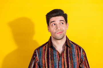 Portrait of nice young man look empty space wear shirt isolated on yellow color background
