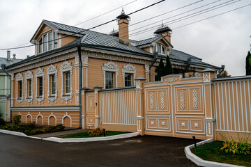 KOLOMNA, RUSSIA - OCTOBER 1, 2024: Facade of vintage wooden house with ornamental carved windows, frames in Kolomna town, Moscow region, Russia. Russian traditional national folk style in architecture