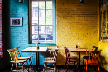Colorful Cafe Setting with Aligned Tables and Chairs by a Sunlit Window – Modern Restaurant Interior