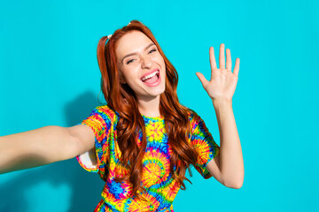 Photo portrait of lovely young lady take selfie photo wave hand hi dressed stylish colorful garment isolated on cyan color background © deagreez