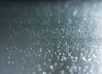 blurred photo of water droplets on a glass surface, with light refracting through them to create an intricate and mesmerizing pattern