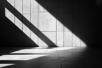 Fototapeta premium Dramatic geometric shadows create abstract patterns on a concrete wall, evoking a sense of minimalism and modern architectural design.