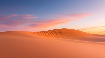 Fototapeta premium Tranquil Light Orange Dunes Under a Pale Pink Sky - Serene Desert Landscape with Smooth Textures and Gentle Winds in Pastel Hues