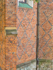 Detailed view of a brick wall showcasing intricate patterns and textures, highlighting the craftsmanship of traditional architecture.