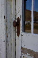 antique door hardware on a rustic abandoned building