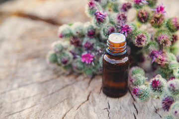 Burdock extract in a bottle. Selective focus.