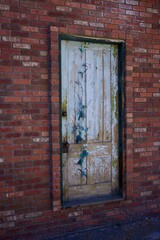 old wooden door in a brick wall