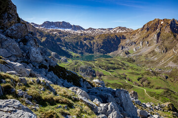 Panoramic view of the mountains of the Somiedo Natural Park in Asturias, Spain, with a spectacular view from the top in the middle of spring, snow on the peaks and grass in the valleys