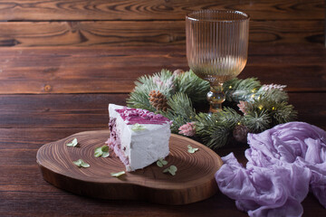 New Year's dessert on a wooden board decorated with fir branches. Modern Wine glass, New Year's Concept
