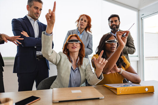 Business team experiencing virtual reality during meeting