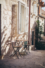 garden chairs and table on patio in backstreet of Old Town, Dubrovnik, Croatia