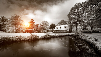 Beautiful house in the winter with snow covered ground and a frozen pond