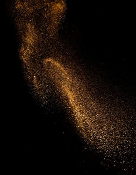 vertical sgot of Abstract magic gold dust background over black. Beautiful golden art widescreen background
