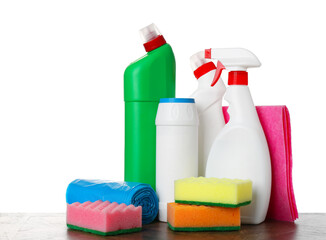 Different toilet cleaners, sponges, rag and trash bags on wooden table against white background
