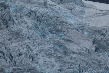 Aerial close-up of a section of the icy patterns of a glacial mass in norwegian national park. Mountains and glaciers make up the stunning landscape that can only be fully appreciated from the air