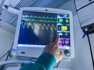 hospital monitors displaying vital signs, including heart rate, oxygen levels, and blood pressure. Represents the precision and urgency of medical care, life monitoring, and patient well-being