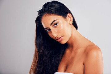 Naklejka premium Woman, portrait and beauty in studio for hair care, luxury salon treatment and healthy texture with glow. Female person, face and keratin on white background for hairstyle, hairdresser and shampoo