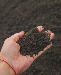 Man holding soil in his hands. Selective focus.
