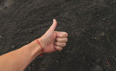 Man holding soil in his hands. Selective focus.