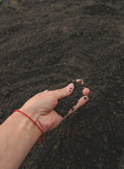 Man holding soil in his hands. Selective focus.