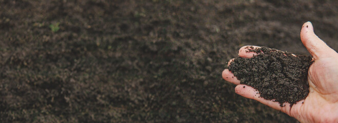 Man holding soil in his hands. Selective focus.