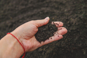 Man holding soil in his hands. Selective focus.
