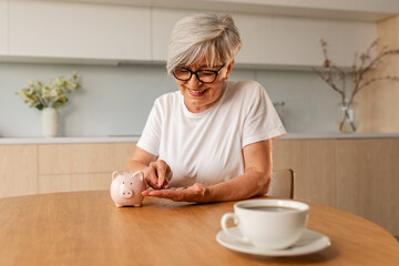 Saving money investment for future. Senior adult mature woman putting money coin in piggy bank. Old grandmother counting saving money planning retirement budget. Investment banking concept