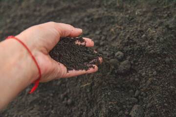 Man holding soil in his hands. Selective focus.