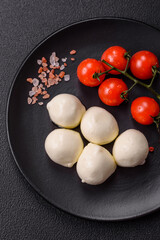 Delicious fresh mozzarella cheese with tomatoes, salt and spices