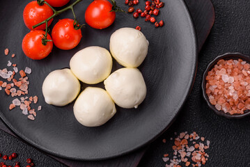 Delicious fresh mozzarella cheese with tomatoes, salt and spices
