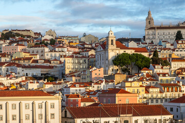 Fototapeta premium Panoramic Exposure done from a Cruise ship in the Cruise Ship terminal in Lisbon at Sunrise, of the Alfama neighborhood upon departure on the tagus river, Portugal