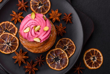Sweet craffin or panettone garnished with raspberry and pistachio flavored cream